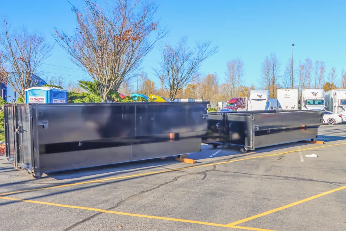 Professional dumpster rental service with roll-off container on residential driveway in Glasgow Village